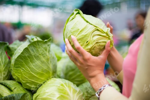 Preview: Woman buying vegetables on the market