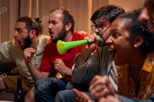 Preview: Close up of Best friends watching sport competition on tv at home, enjoying good game.