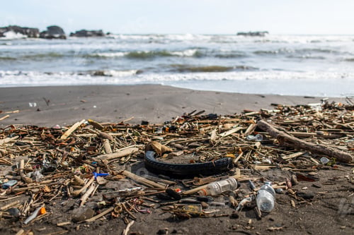 Preview: Beach pollution with plastic bottles, rubber tyre and other waste in Bali, Indonesia