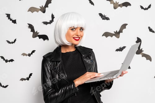 Preview: attractive woman in white wig holding laptop in Halloween