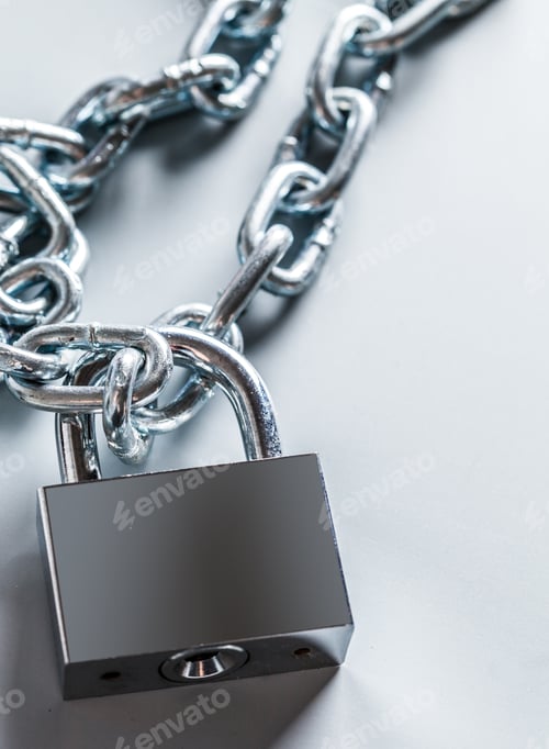 Preview: Lock and chain resting on a plain surface for security purpose