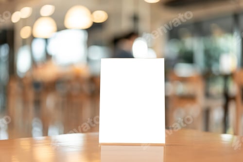 Preview: Menu frame with white blank screen on wooden table in restaurant or cafe on bokeh background