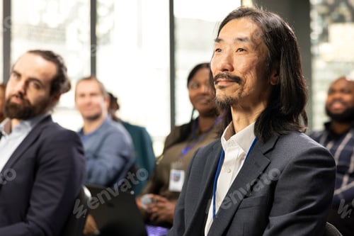 Preview: Asian entrepreneur attending business conference and listening to discussion