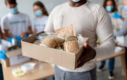 Preview: Senior black man holding box with donations food, cans and packages with grains and pasta, cropped
