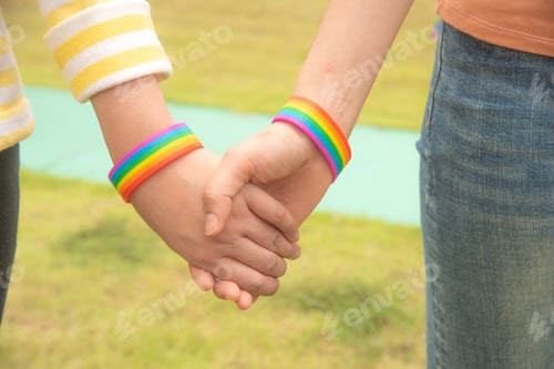 Preview: Diversity people hands together and wear Rocket Wristband , a symbol for the LGBT community