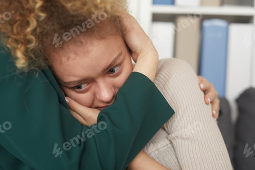 Preview: Sad woman embracing with her friend