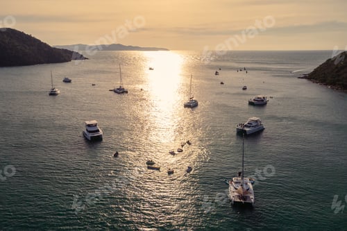 Preview: G\roup of private yacht sailing on tropical sea at the sunset