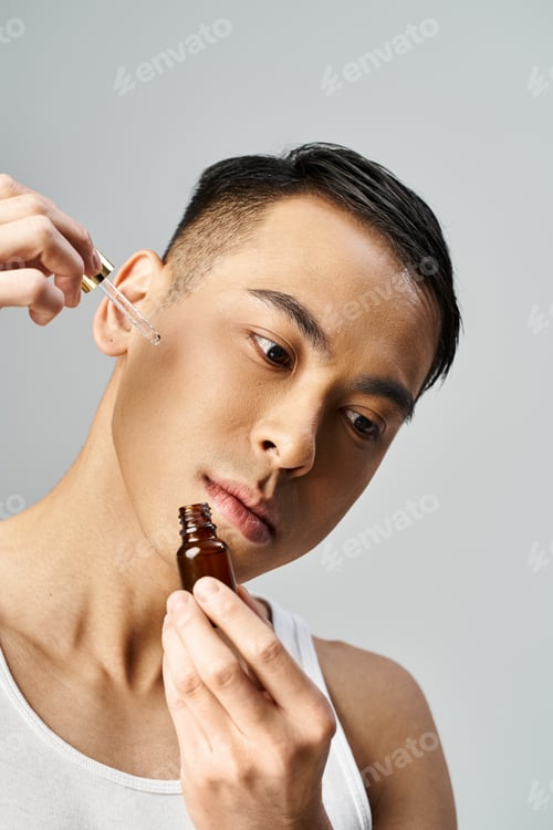 Preview: asian man with bottle with serum