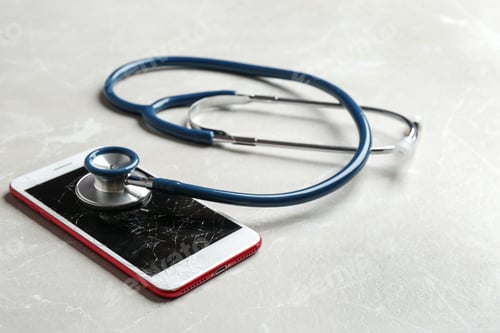 Preview: Modern smartphone with broken display and stethoscope on table. Device repair service