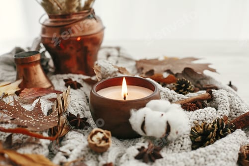 Preview: Hello autumn, cozy inspirational image.Hygge lifestyle. Candle with berries, fall leaves