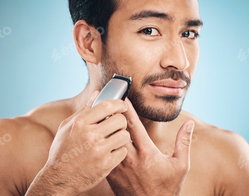 Preview: Portrait,, electric shaving and grooming with a man in studio on a blue background for personal hyg