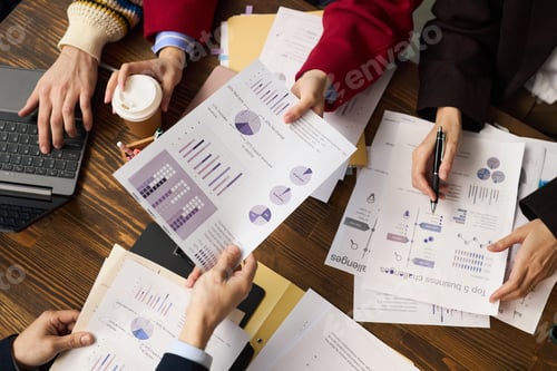 Preview: Diverse Group of Young Adults Analyzing Financial Charts during Meeting