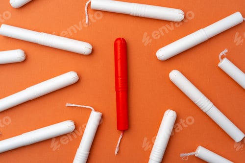 Preview: Medical female tampons on orange background top view
