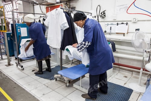 Preview: Workers ironing shirt in garment factory