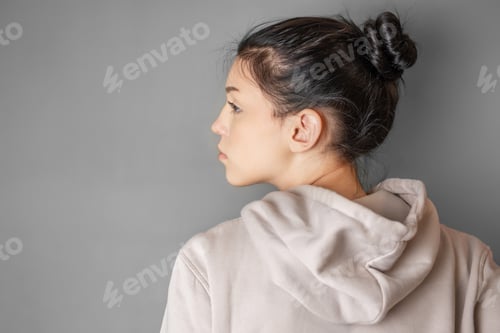 Preview: Pensive thoughtful young girl wearing sweatshirt with hood