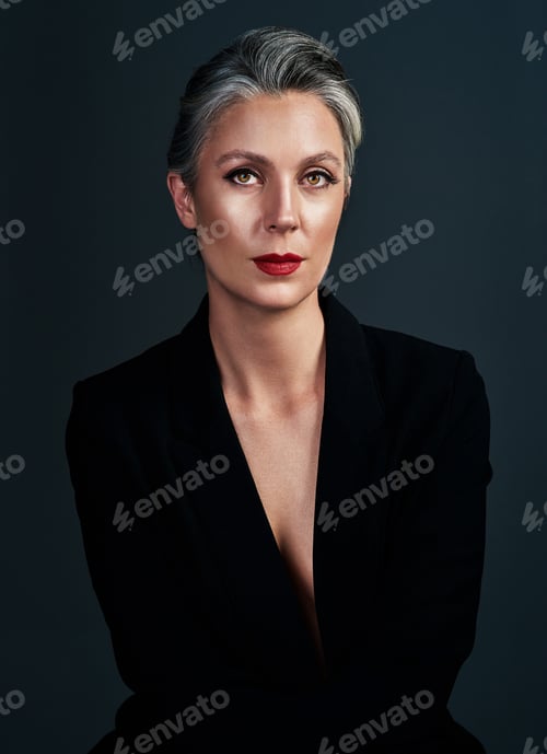 Preview: Studio portrait of a beautiful mature woman posing against a dark background