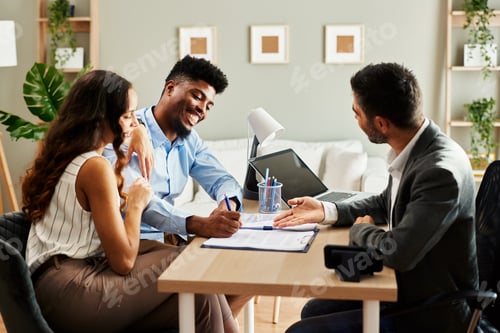 Preview: Young couple signing a contract with an agent in the office