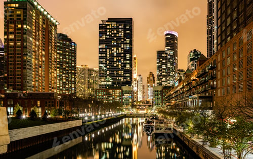 Preview: Chicago city illuminated buildings in the evening. Reflections on the river canal