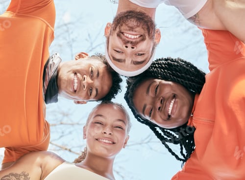 Preview: Low angle shot of a diverse group of friends standing huddled together after their workout