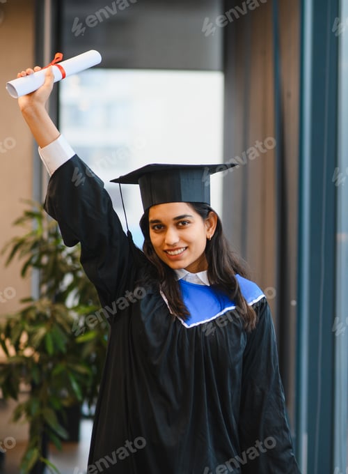 Preview: Indian student celebrating graduation, holding diploma scroll