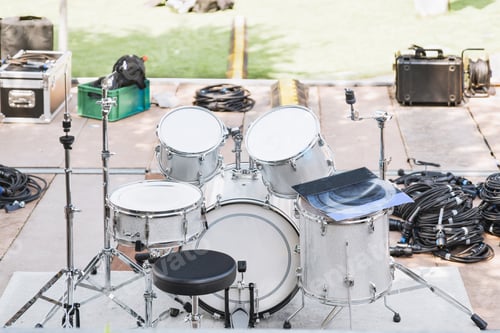 Preview: White drums and cymbals on an empty stage