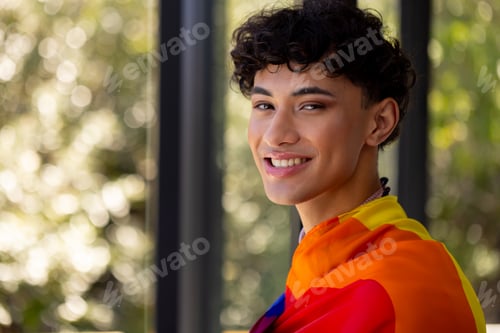 Preview: Smiling Person Wrapped in a Rainbow Colored Fabric