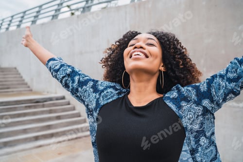 Preview: Afro american woman with arms raised.