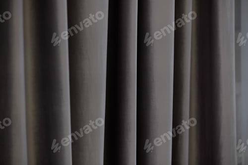 Preview: Soft gray curtains gently draping in a modern living space under natural light