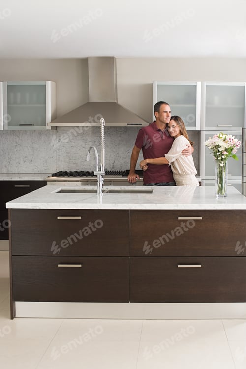 Preview: Couple hugging in kitchen