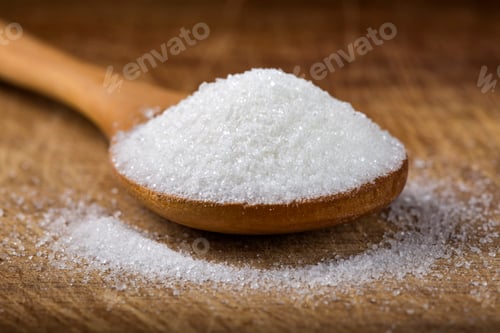 Preview: bamboo spoon filled with white sugar over wooden background