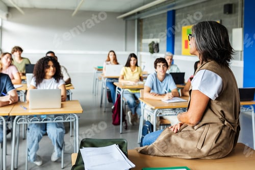Preview: Senior adult teacher giving a lecture to her high school students at classroom