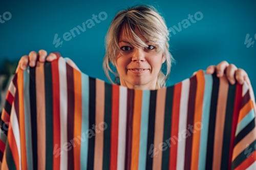 Preview: Portrait of a woman tailor holding colorful fabrics