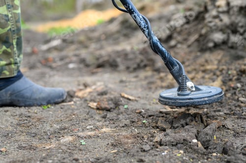Preview: coil electronic metal detector device for search a treasure on ground background