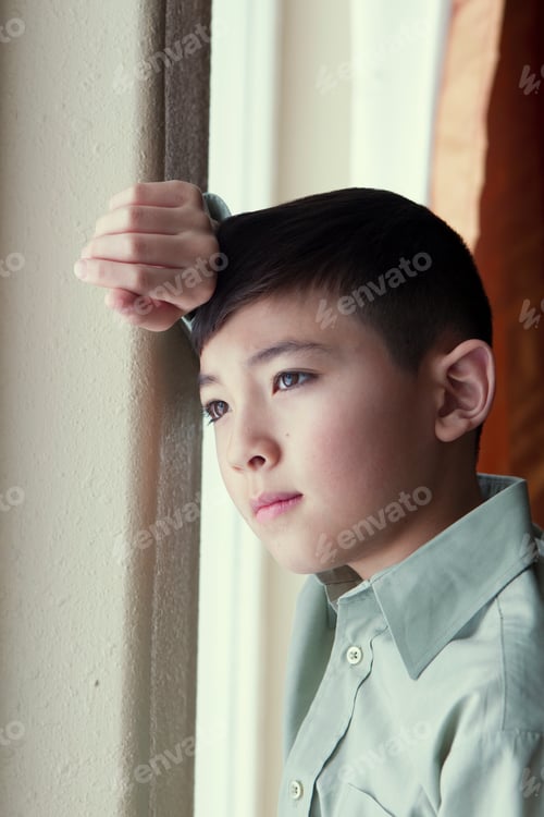 Preview: Boy deep in thought.