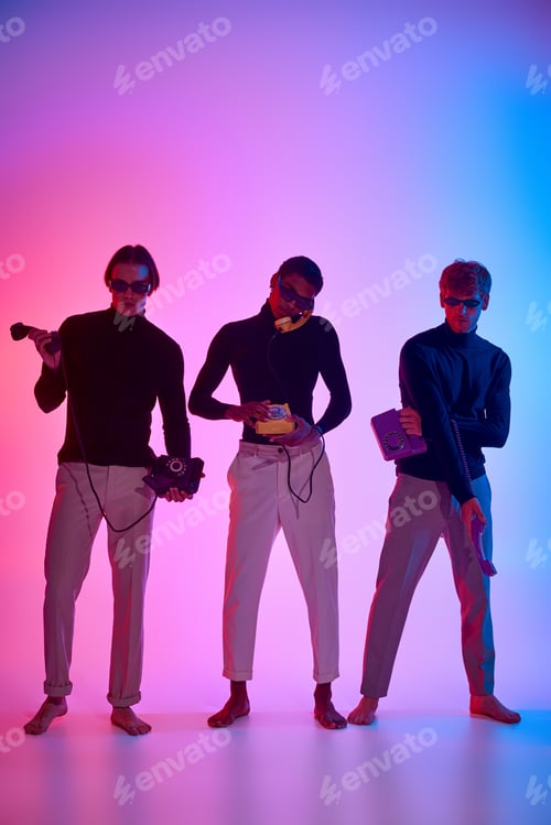 Preview: good looking multiethnic male models encircled by neon lights posing with landline phones, men power