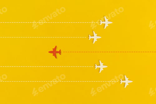 Preview: Toy airplanes on a yellow background. Leadership and new idea concept.