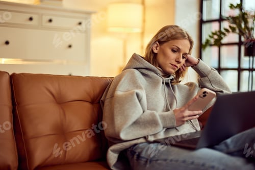 Preview: Woman Relaxing on Sofa with Phone and Laptop