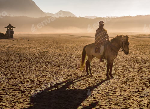 Preview: Java Island, Indonesia - August, 14 2015: Anonymous person on horse near volcano