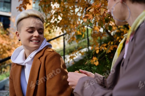Preview: Lgbt female couple communicating in the autumn city park