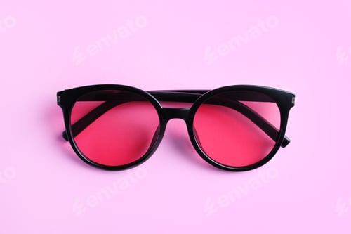 Preview: Stylish sunglasses on light violet background, top view