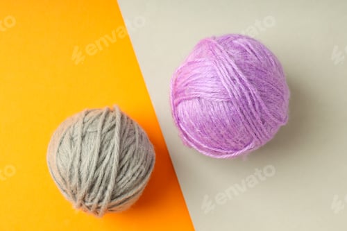 Preview: Multi colored balls of yarn on two tone background