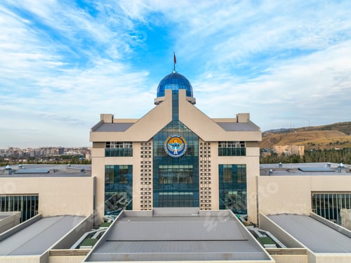 Preview: Central facade of Yntymak Ordo under blue sky