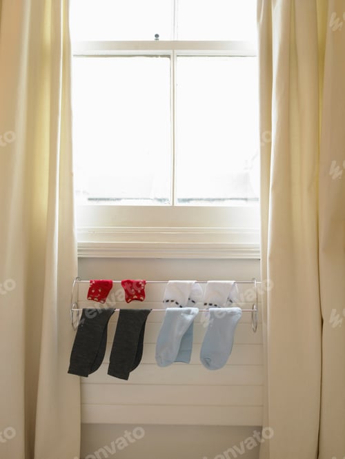 Preview: Socks hanging on rack over radiator