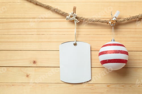 Preview: clothespin hanging with blank paper on wooden background
