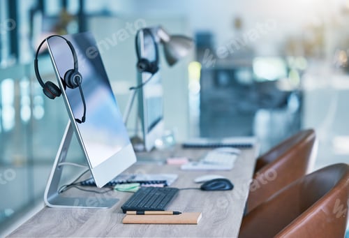 Preview: Headphone or headset at empty office at call center with computer monitor display for online custom