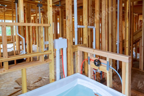 Preview: Interior wall framing with piping and bathroom installed Plumbing pipes and exposed beams.