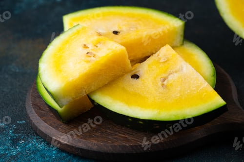 Preview: Cut yellow watermelon on table. Fresh summer food. Healthy nutrition
