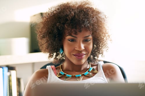 Preview: Good-looking black girl looking at desk-top