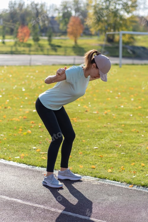 Preview: A young beautiful woman in sportswear plays sports at a local stadium
