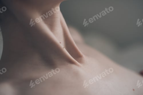 Preview: Closeup shot of the neck and chest of a man against a blurred background